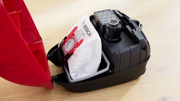 Inside of a bagged Bosch vacuum cleaner showing the dust bag and filter