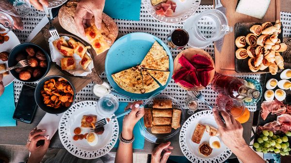 Overhead shot of people eating from multiple dishes of food