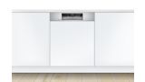 Semi-integrated Bosch dishwasher with a stainless steel control panel, in a modern white kitchen.