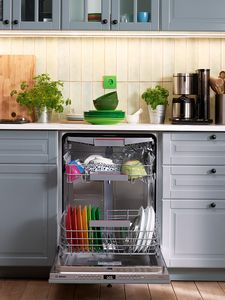 Bosch dishwasher in kitchen unit with door down showing items inside
