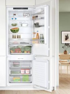 A modern refrigerator with an open door, filled with fresh produce, drinks, and various food items on shelves 