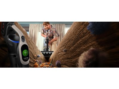 Person vacuuming dirt in floor