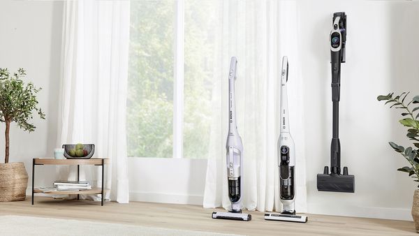 A selection of cordless vacuum cleaners in a living room.