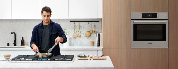 Person cooking in Bosch kitchen