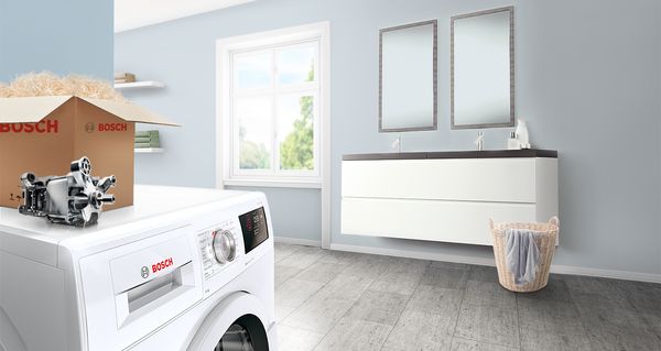 A modern laundry room featuring a Bosch washing machine, a box, and a sleek vanity with mirrors, creating a clean and airy ambiance.
