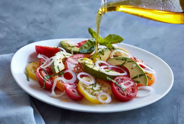 A fresh salad with oil dressing, visually appealing. 