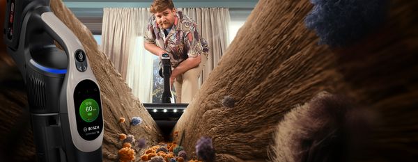 Person vacuuming dirt in floor