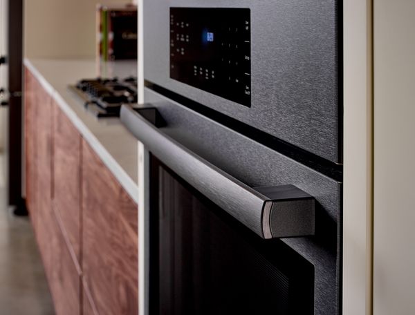 A detailed view of a warehouse kitchen featuring Bosch appliances, with a focus on the workspace and storage areas. 